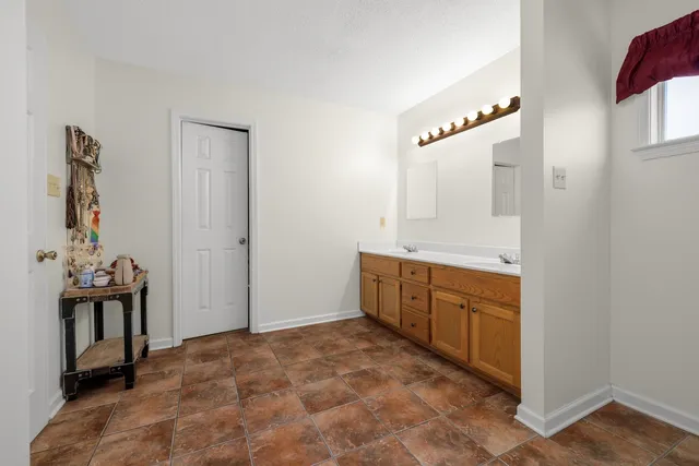 a bedroom with a bed and a desk