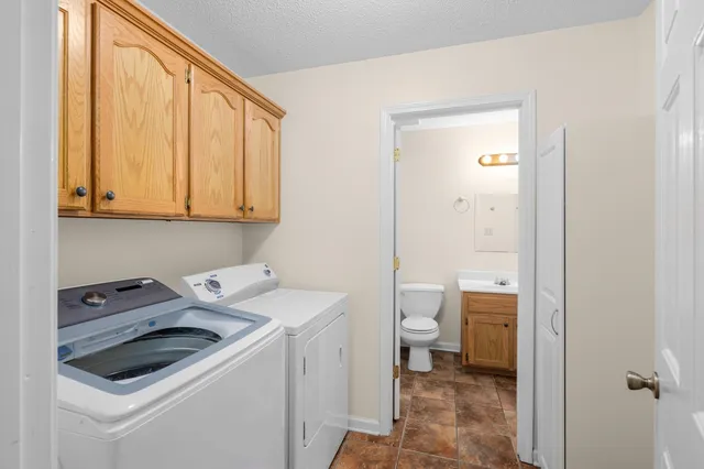 a bathroom with a sink a toilet a shower and a mirror