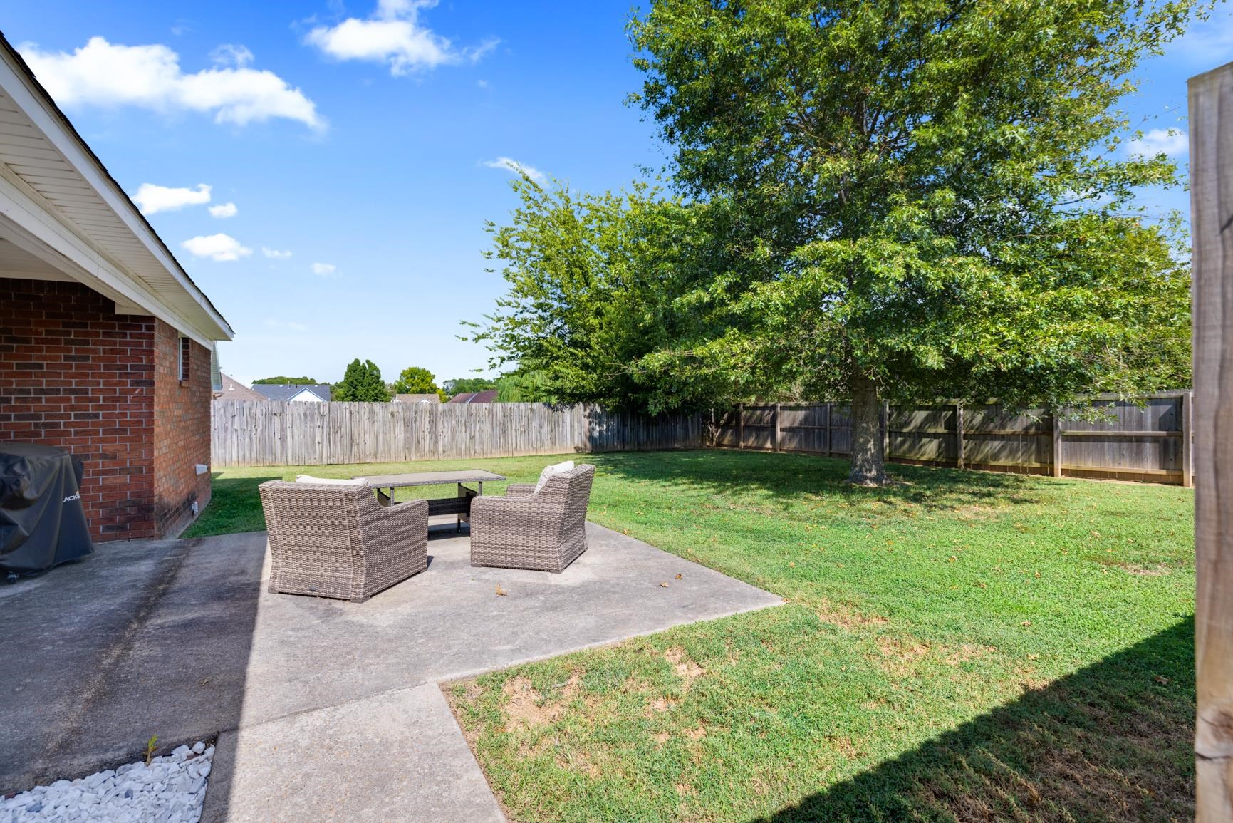 538 Rosemark Road Atoka, TN 38004 - Photo 4 of 25 a view of a patio with table and chairs potted plants and a large tree