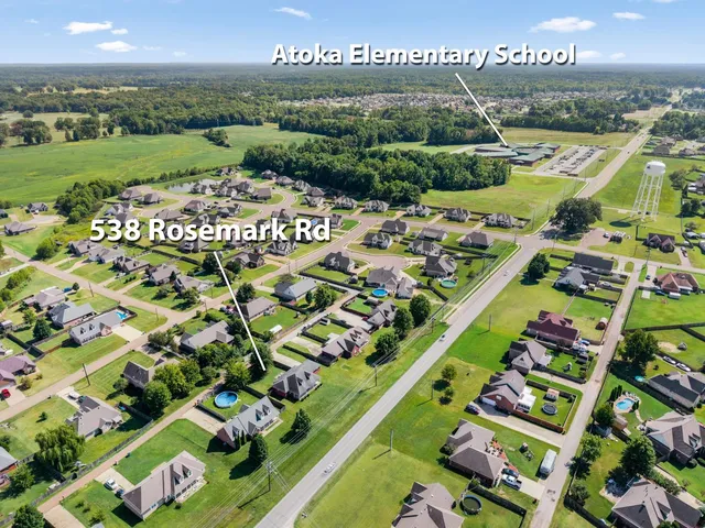 an aerial view of a house with a swimming pool yard and outdoor seating