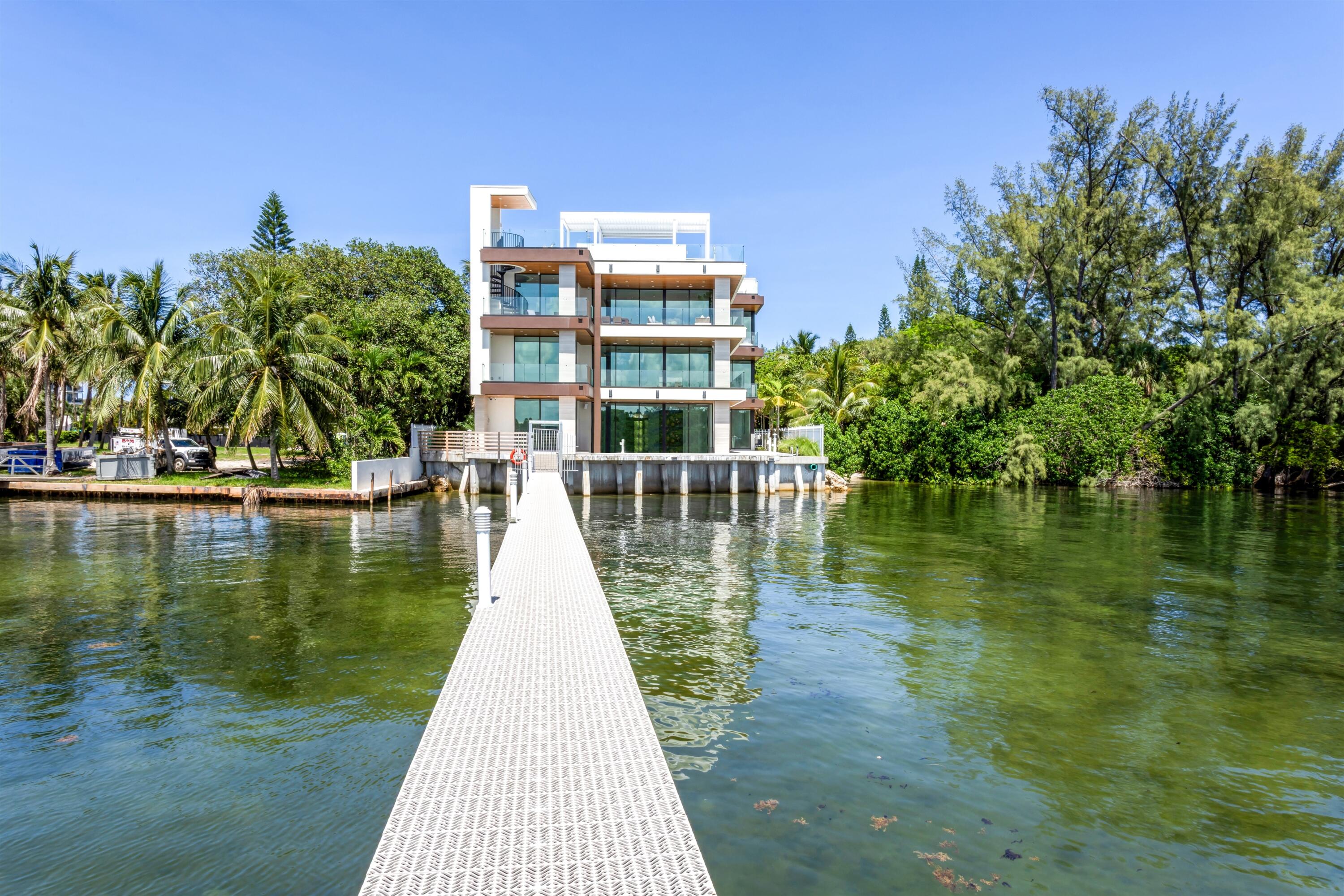 900 Lago Mar Lane, Unit PH Boca Raton, FL 33431 - Photo 42 of 58 a view of a lake with a building in the background