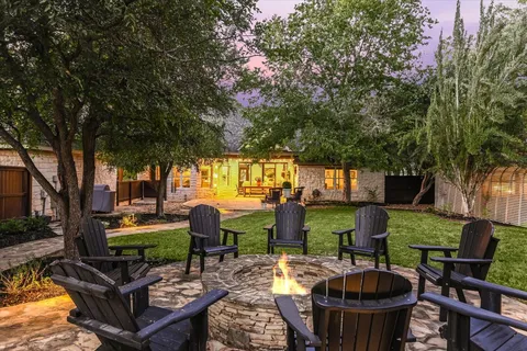 a view of a backyard with swimming pool table and chairs