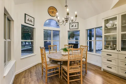 a large kitchen with stainless steel appliances a large center island attached withe living room