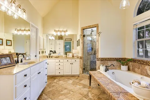 a spacious bedroom with a bed and glass door