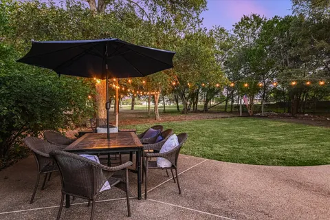 a view of a park with furniture and garden