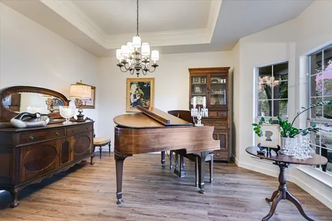 a view of a dining room with furniture wooden floor and chandelier