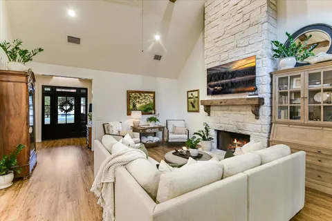 a living room with furniture fireplace and flat screen tv