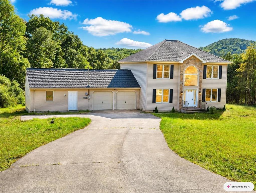 5693 Neola Road Stroudsburg, PA 18360 - Photo 1 of 34 A long paved driveway leads to a multi-level home nestled against a wooded hillside.