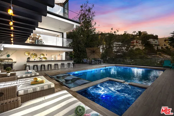 a view of swimming pool with outdoor seating