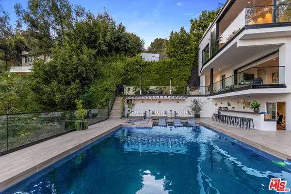 a swimming pool view with a outdoor seating