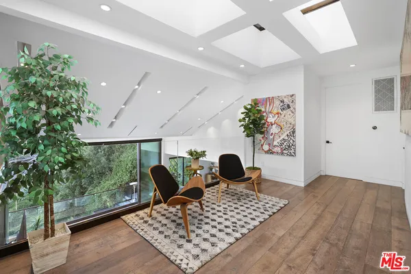 a living room with a couch and a potted plant