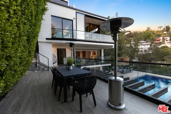 a view of a patio with table and chairs