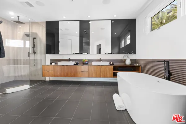 a large white kitchen with a large window