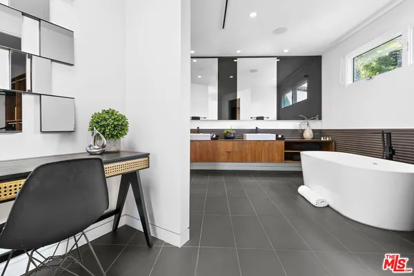 a living room with granite countertop furniture a sink a window and stainless steel appliances