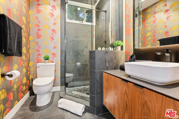 a bathroom with a sink a toilet and shower curtain