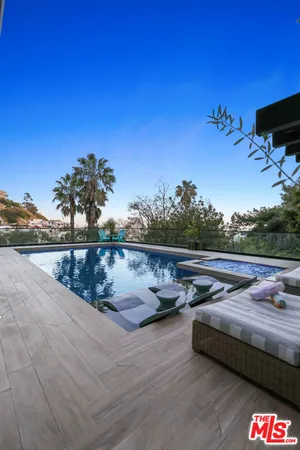 a view of swimming pool with lounge chair