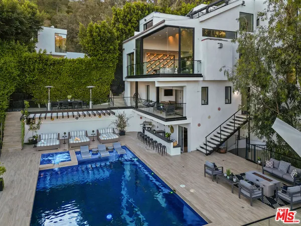 a view of a house with roof deck and furniture