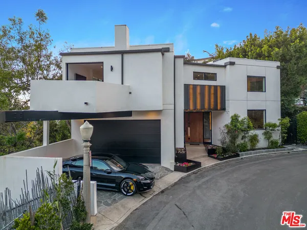 a view of a patio with table and chairs potted plants