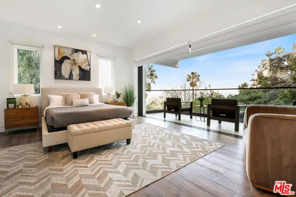 a living room with furniture a rug and a table