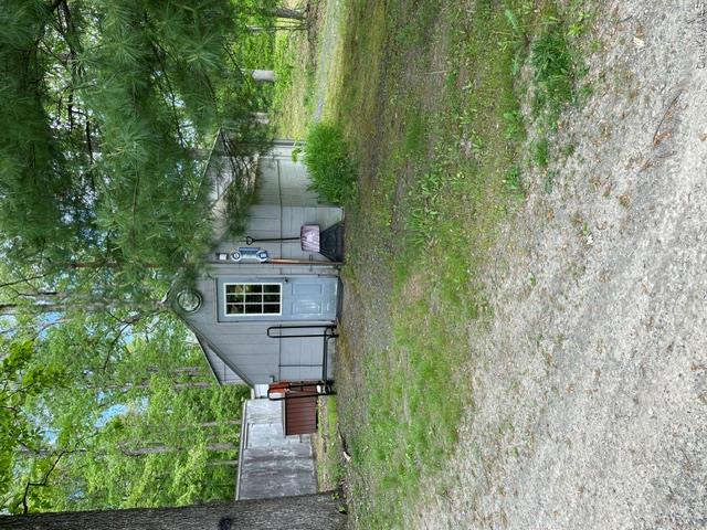100 Decker Road, Unit 2 Wallkill, NY 12589 - Photo 22 of 23 a backyard of a house with plants and large trees