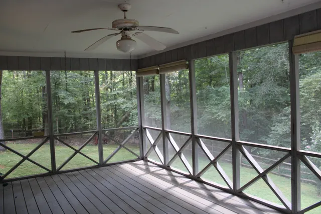 a view of a balcony with chairs and wooden floor