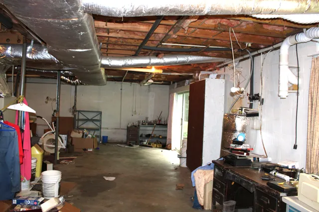 a utility room with wooden floor and sink