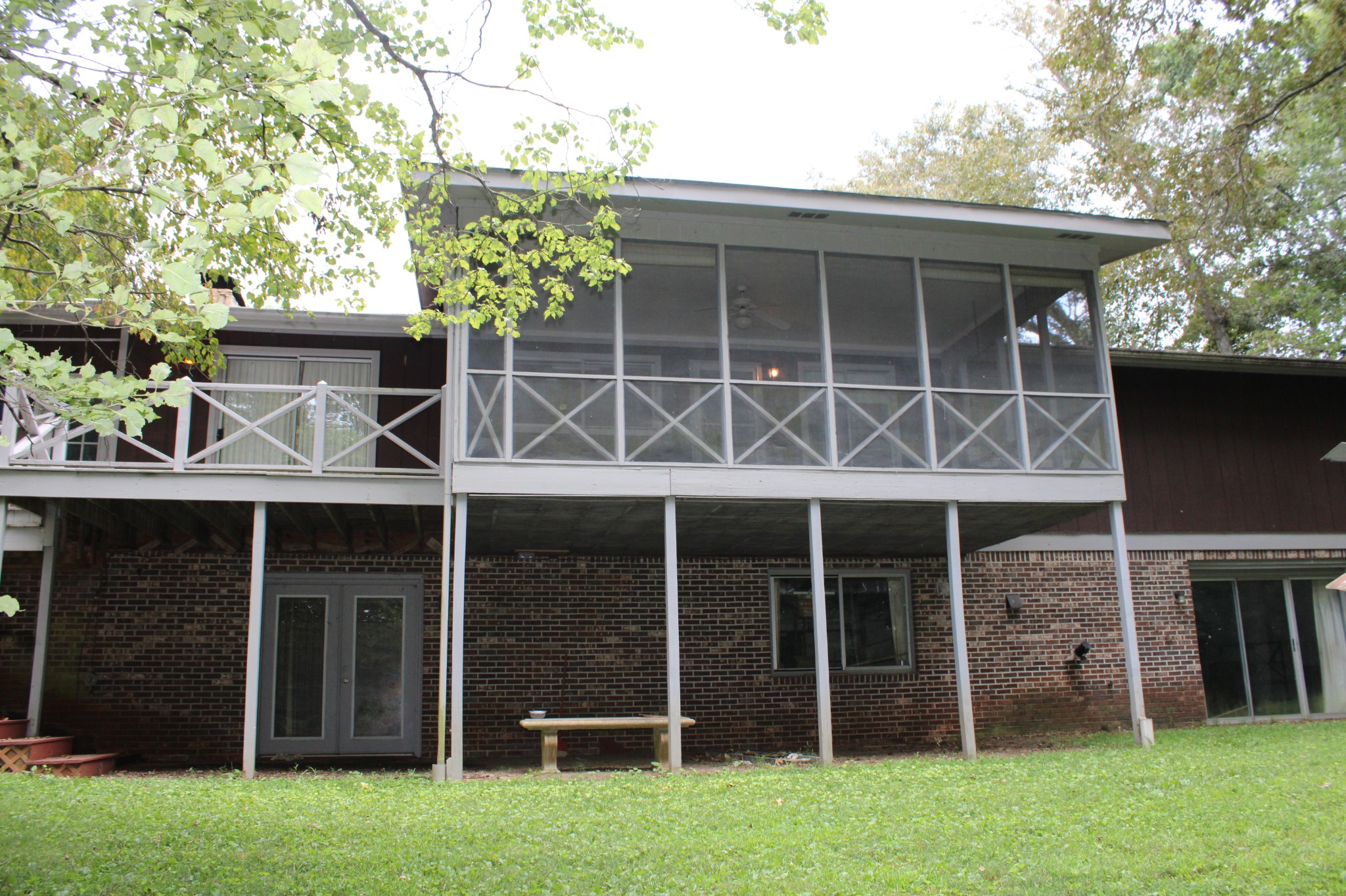200 Primrose Lane Morrison, TN 37357 - Photo 4 of 53 a view of a house with a large window and a yard with wooden fence