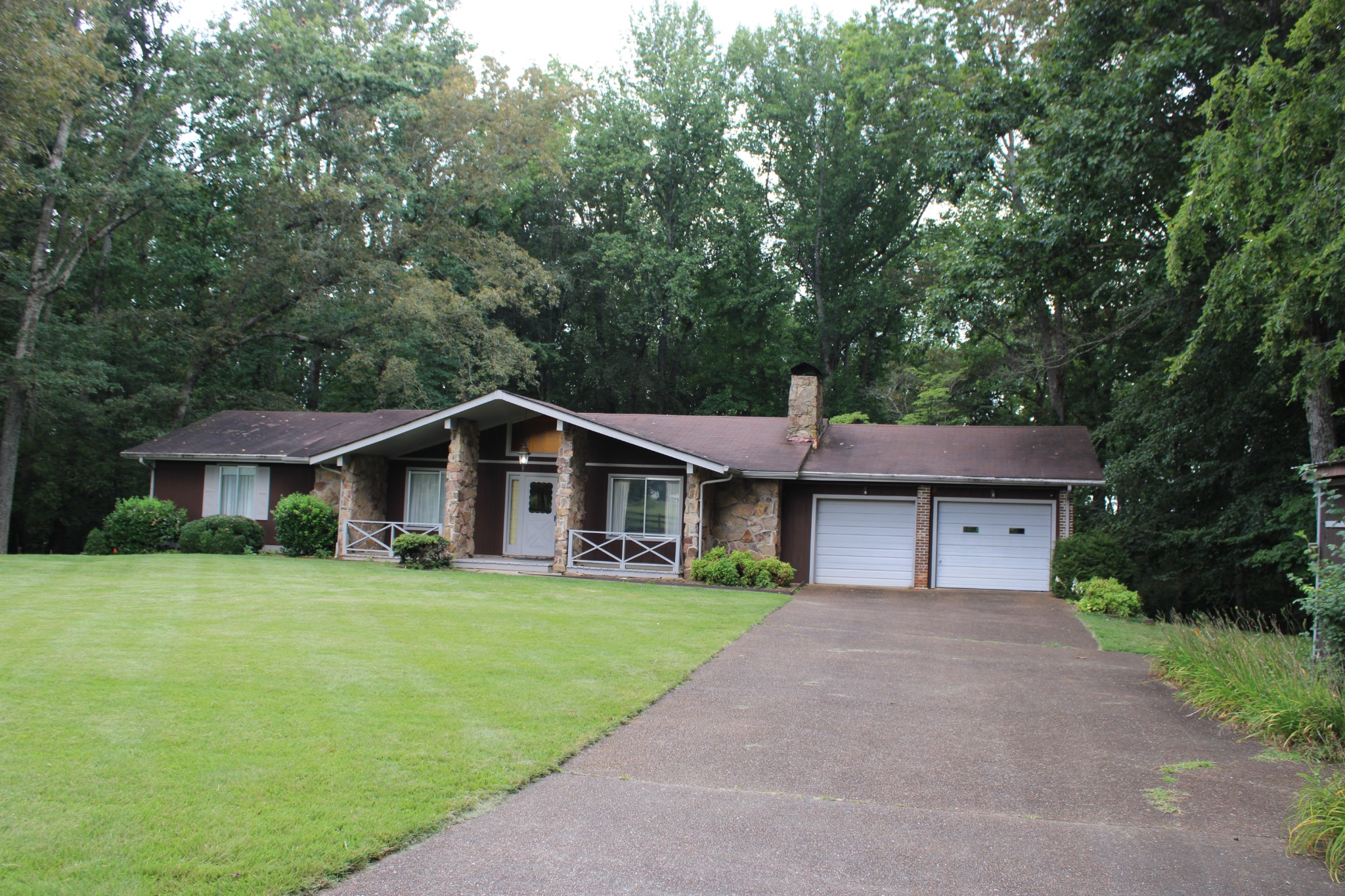 200 Primrose Lane Morrison, TN 37357 - Photo 10 of 53 a front view of a house with a yard and trees