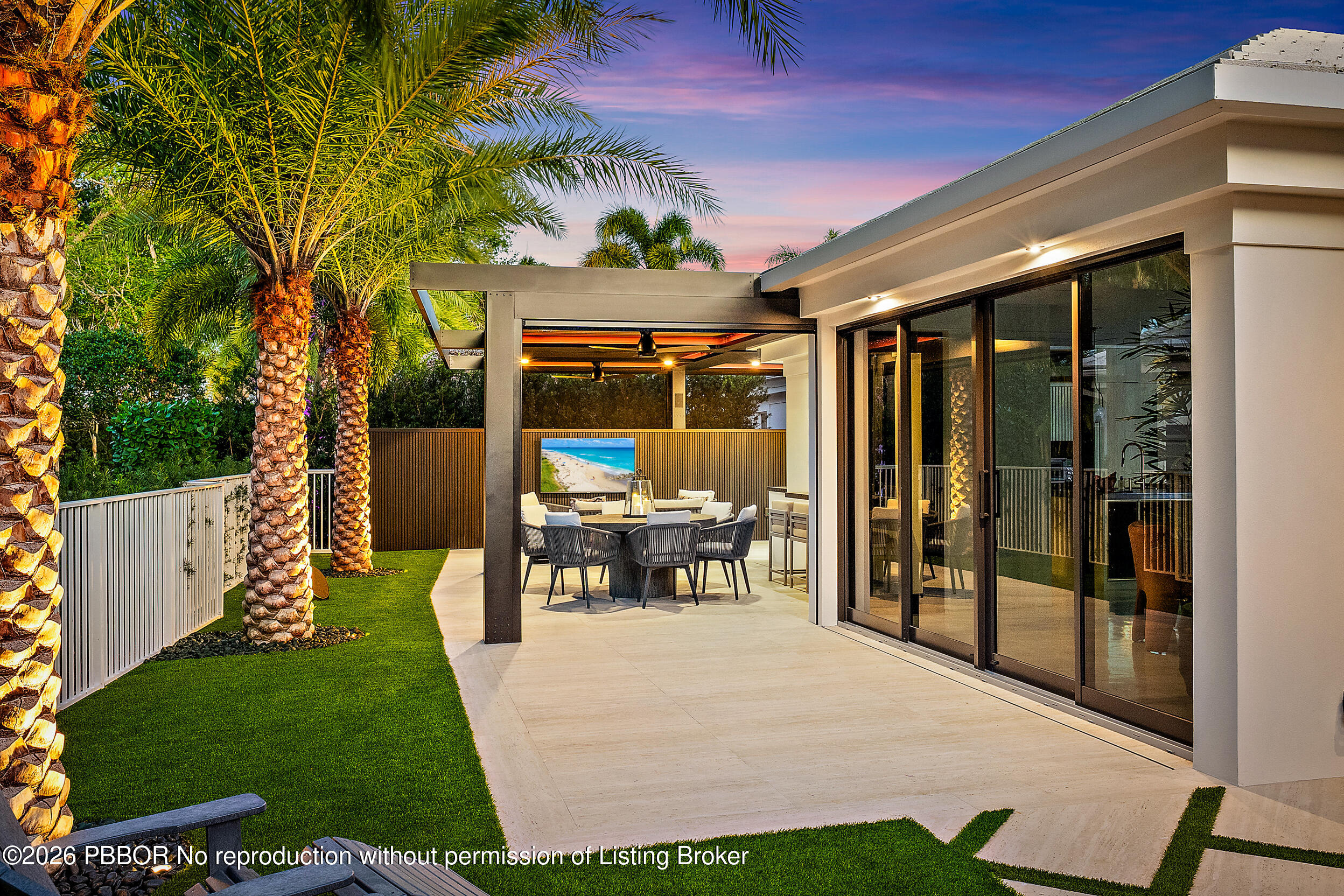 3501 Captains Way, Unit 3501 Jupiter, FL 33477 - Photo 6 of 41 a view of a patio with table and chairs potted plants and floor to ceiling window