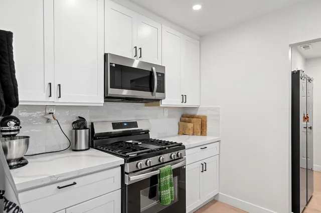 a kitchen with a stove and a microwave