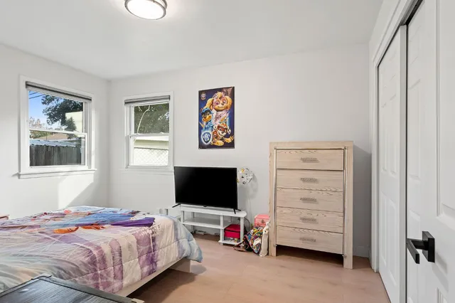 a bedroom with a bed and a flat screen tv