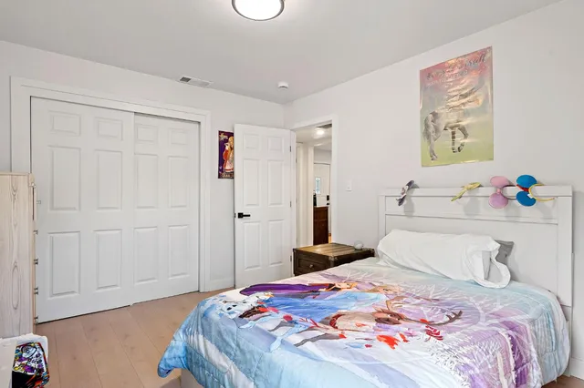 a bedroom with a bed and a window