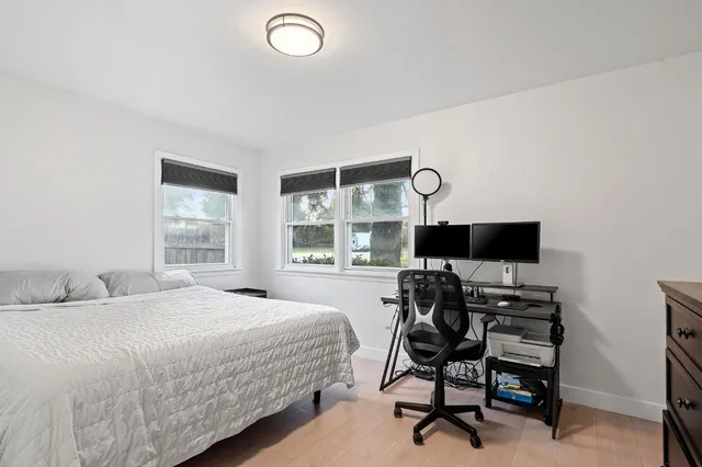 a bedroom with a bed and a desk