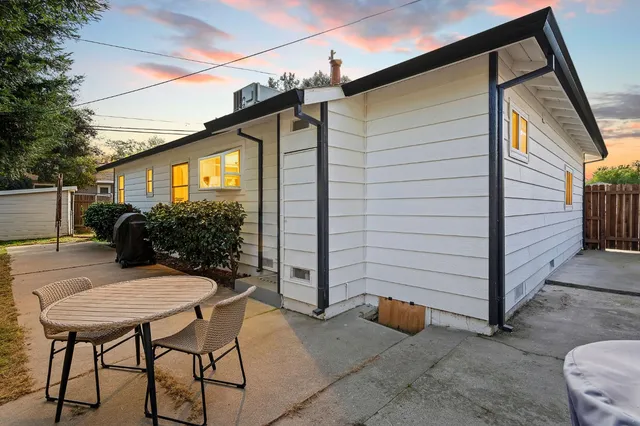 a view of backyard with outdoor seating and plants