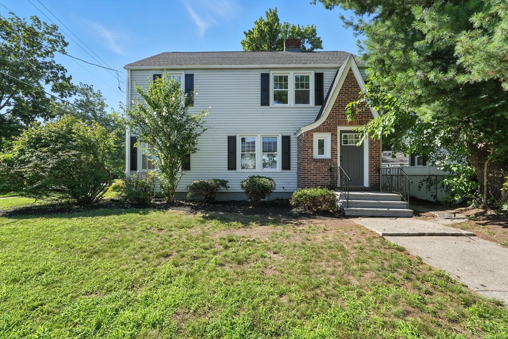 706 Allen Street Springfield, MA 01118 - Photo 1 of 33 a front view of a house with garden