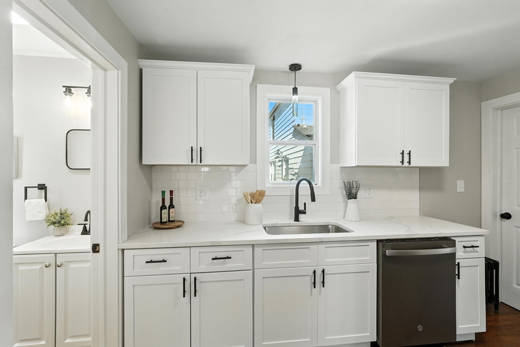 706 Allen Street Springfield, MA 01118 - Photo 13 of 33 a kitchen with cabinets appliances a sink and a window