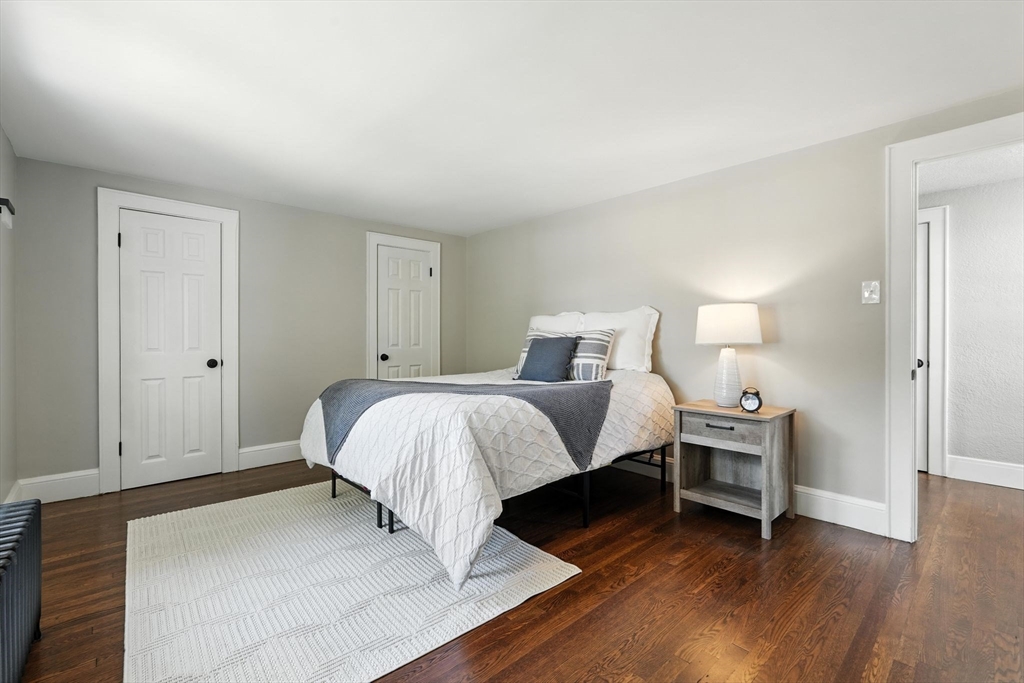706 Allen Street Springfield, MA 01118 - Photo 18 of 33 a bedroom with a bed and wooden floor