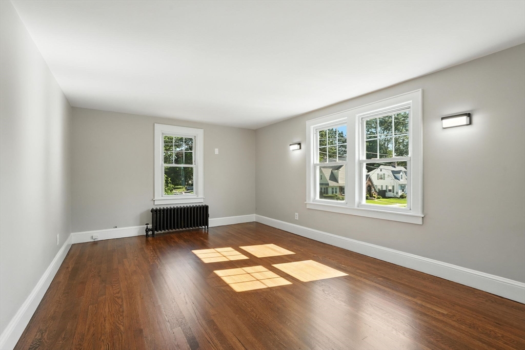 706 Allen Street Springfield, MA 01118 - Photo 23 of 33 an empty room with wooden floor and windows