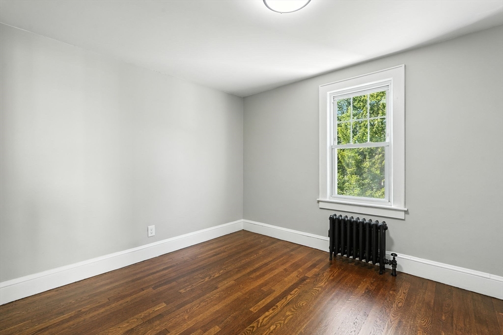 706 Allen Street Springfield, MA 01118 - Photo 25 of 33 an empty room with wooden floor and windows
