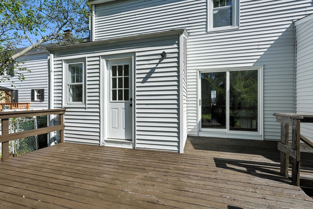 706 Allen Street Springfield, MA 01118 - Photo 30 of 33 a view of a deck with a chair and floor to ceiling window