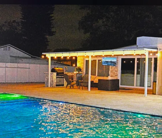 a view of a swimming pool with an outdoor seating