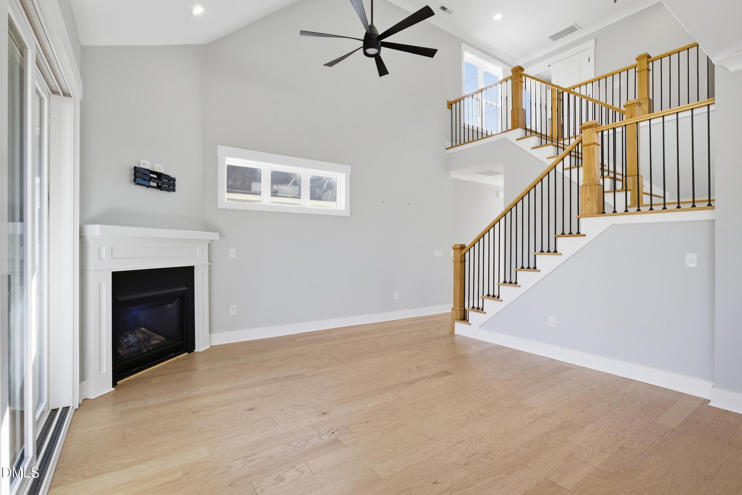 1439 Garner Road Raleigh, NC 27610 - Photo 11 of 37 a view of an empty room with stairs and a fireplace