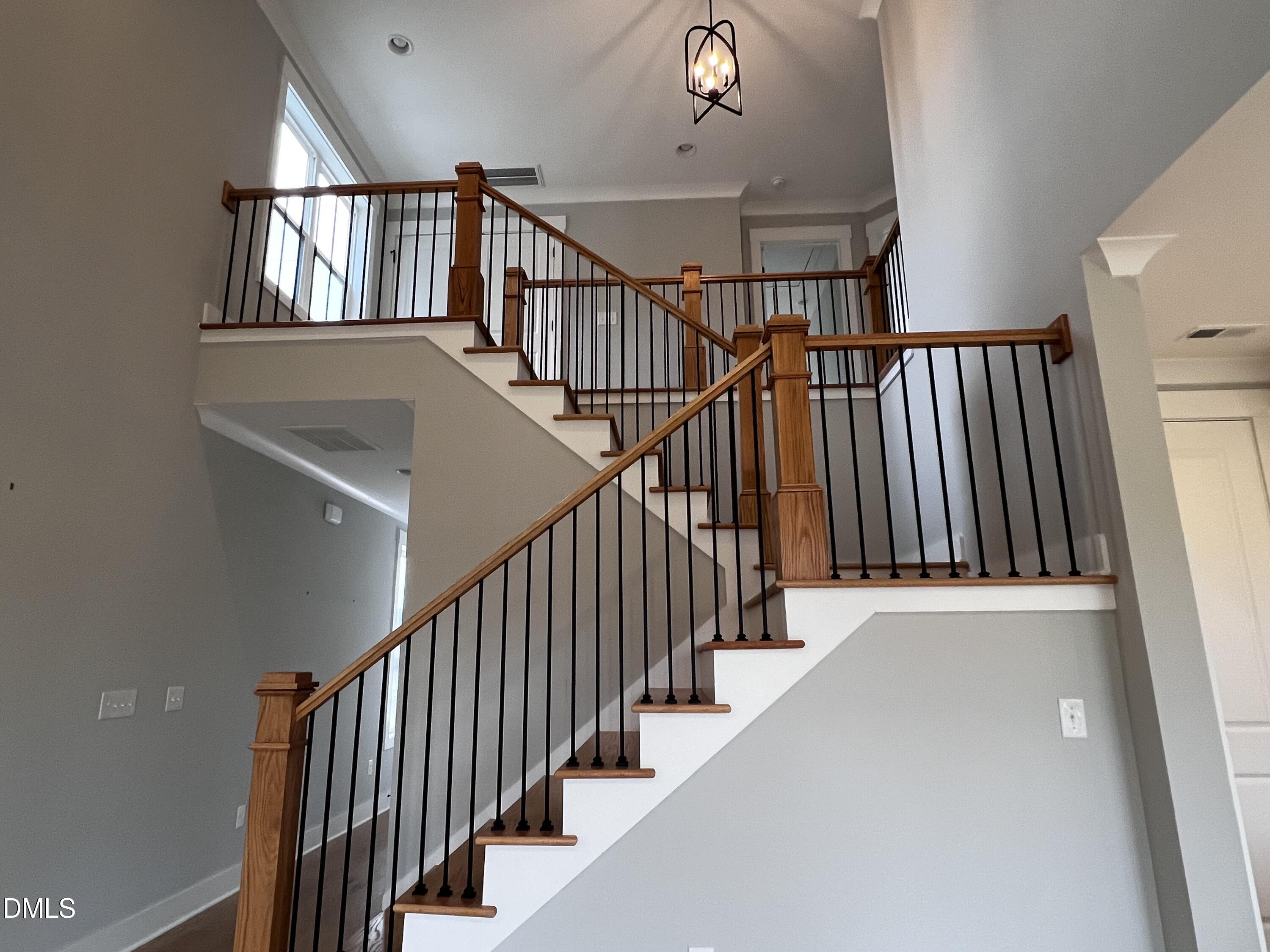 1439 Garner Road Raleigh, NC 27610 - Photo 12 of 28 a view of staircase with lots of frames on wall and a window
