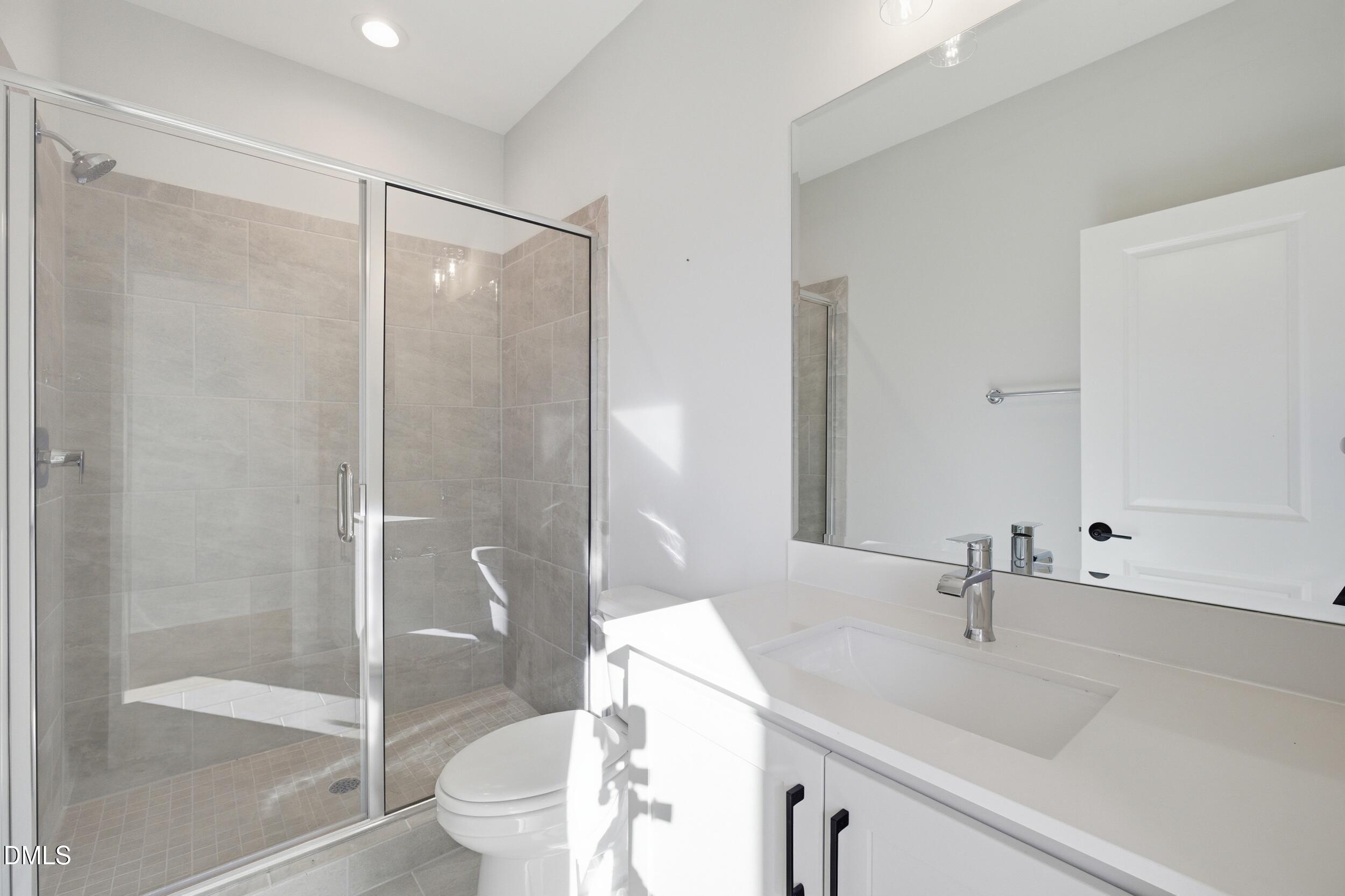 1439 Garner Road Raleigh, NC 27610 - Photo 15 of 37 a bathroom with a sink toilet and shower