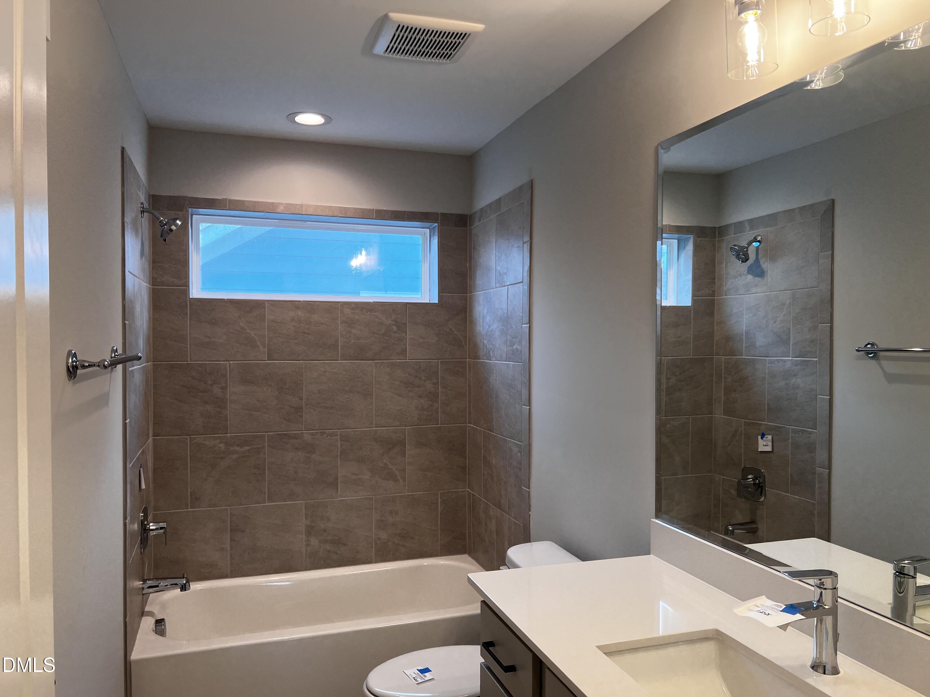 1439 Garner Road Raleigh, NC 27610 - Photo 17 of 28 a bathroom with a sink a toilet and shower