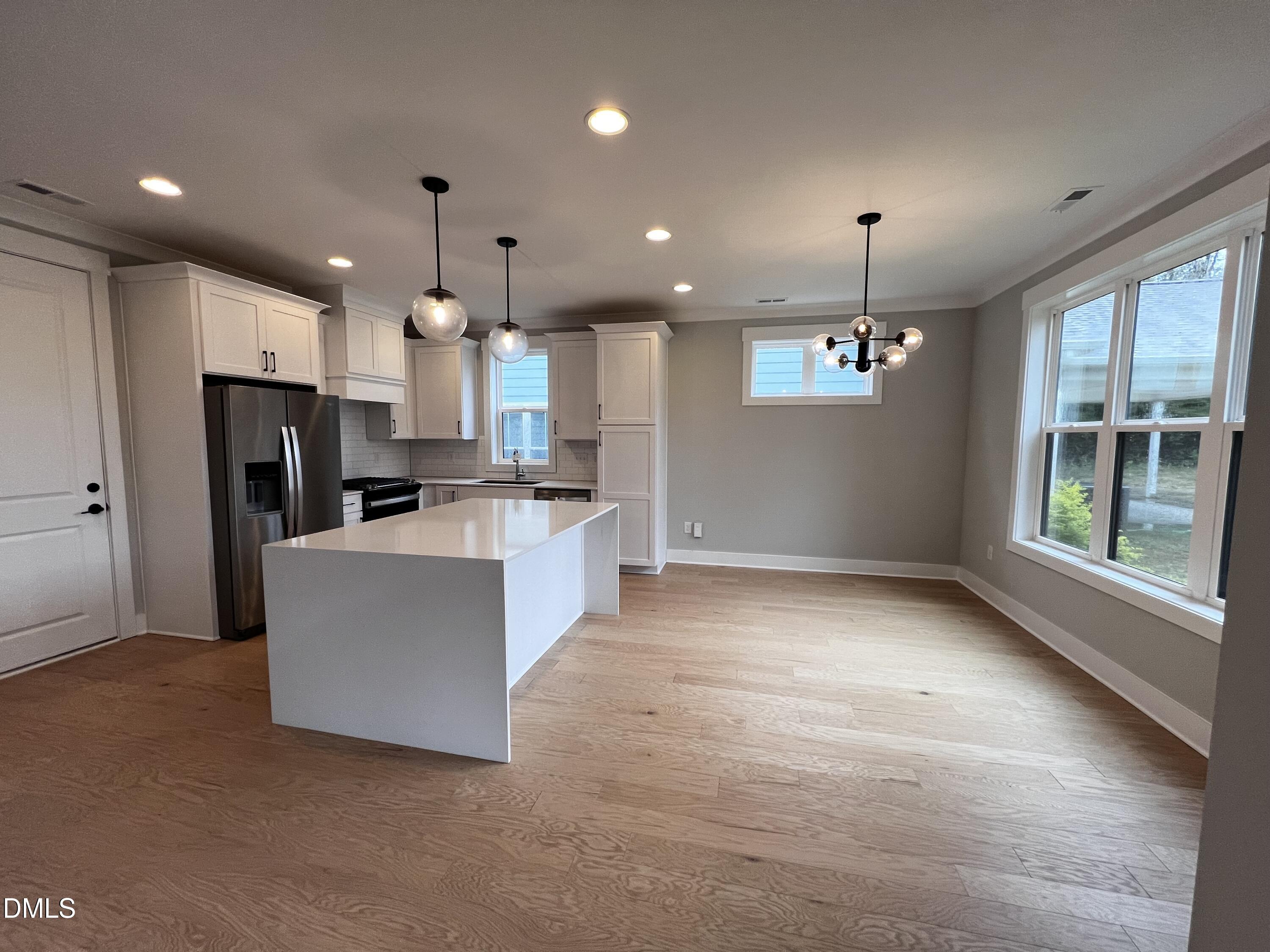 1439 Garner Road Raleigh, NC 27610 - Photo 2 of 28 a view of kitchen with kitchen island stainless steel appliances sink refrigerator and microwave