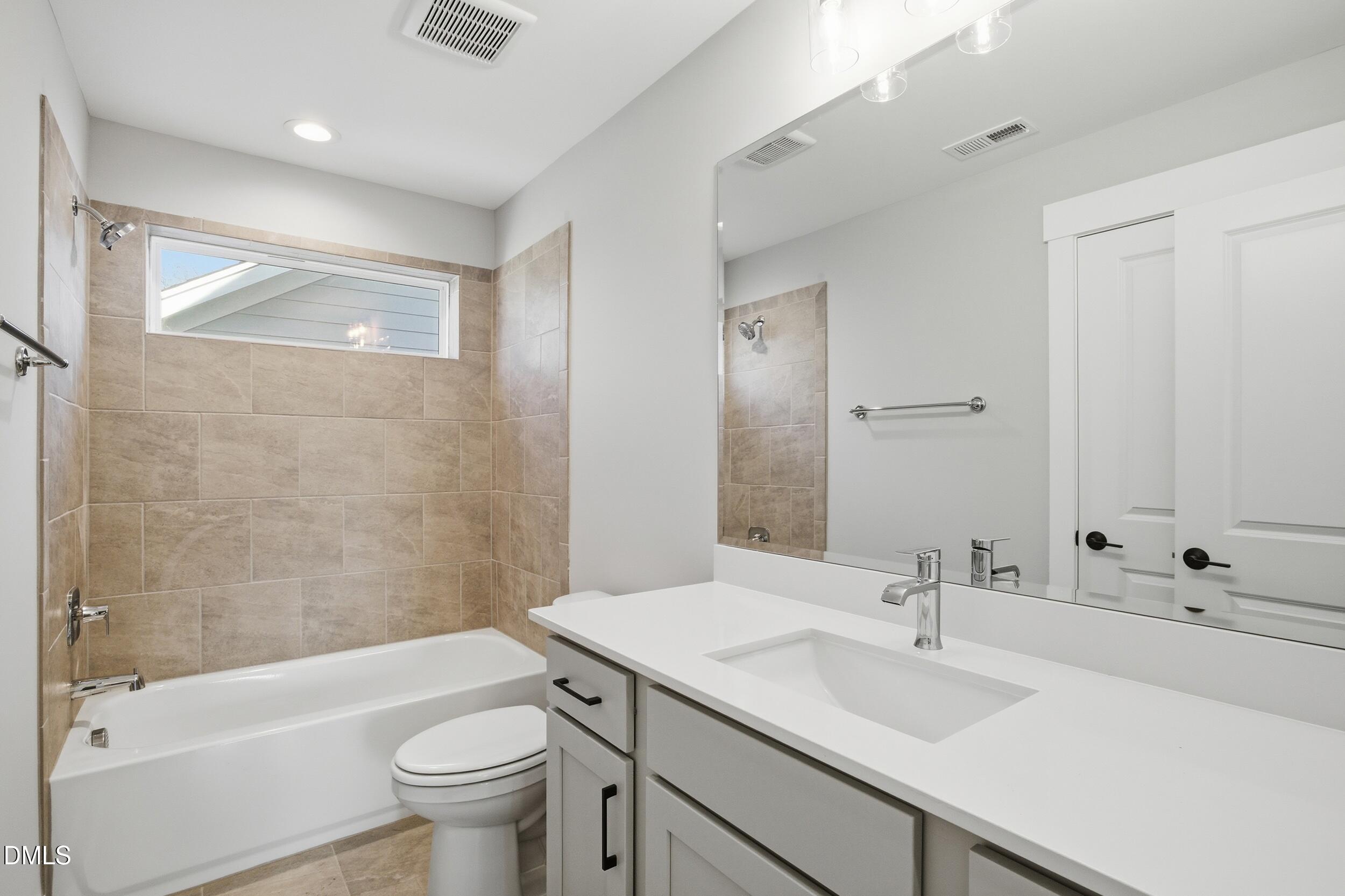 1439 Garner Road Raleigh, NC 27610 - Photo 25 of 37 a bathroom with a sink a toilet and shower