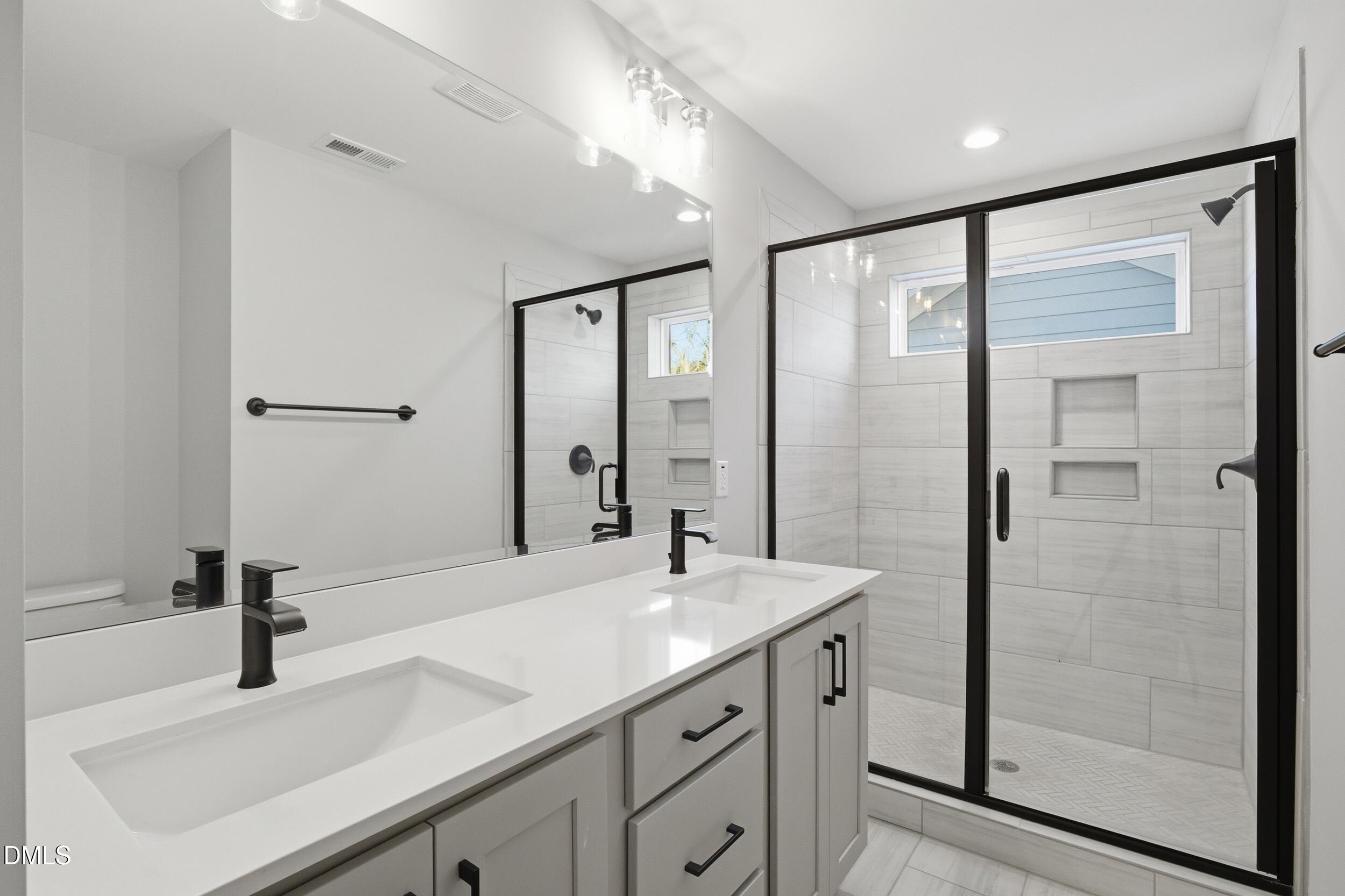 1439 Garner Road Raleigh, NC 27610 - Photo 26 of 37 a bathroom with a sink and a mirror