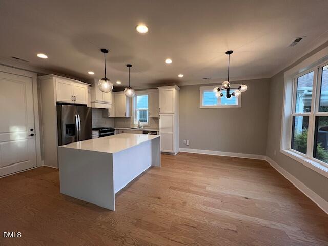 1439 Garner Road Raleigh, NC 27610 - Photo 26 of 28 a large kitchen with kitchen island a large counter space a sink appliances and cabinets