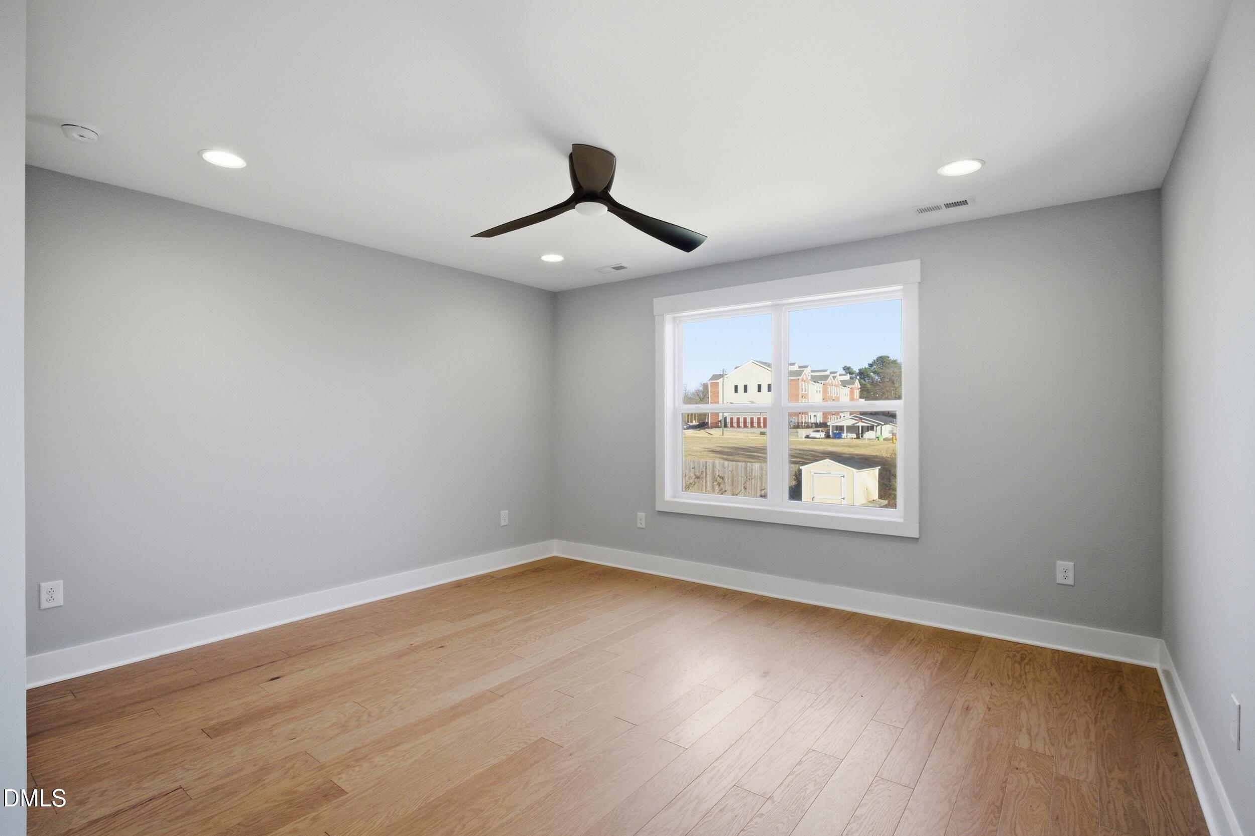 1439 Garner Road Raleigh, NC 27610 - Photo 28 of 37 wooden floor in an empty room with a window